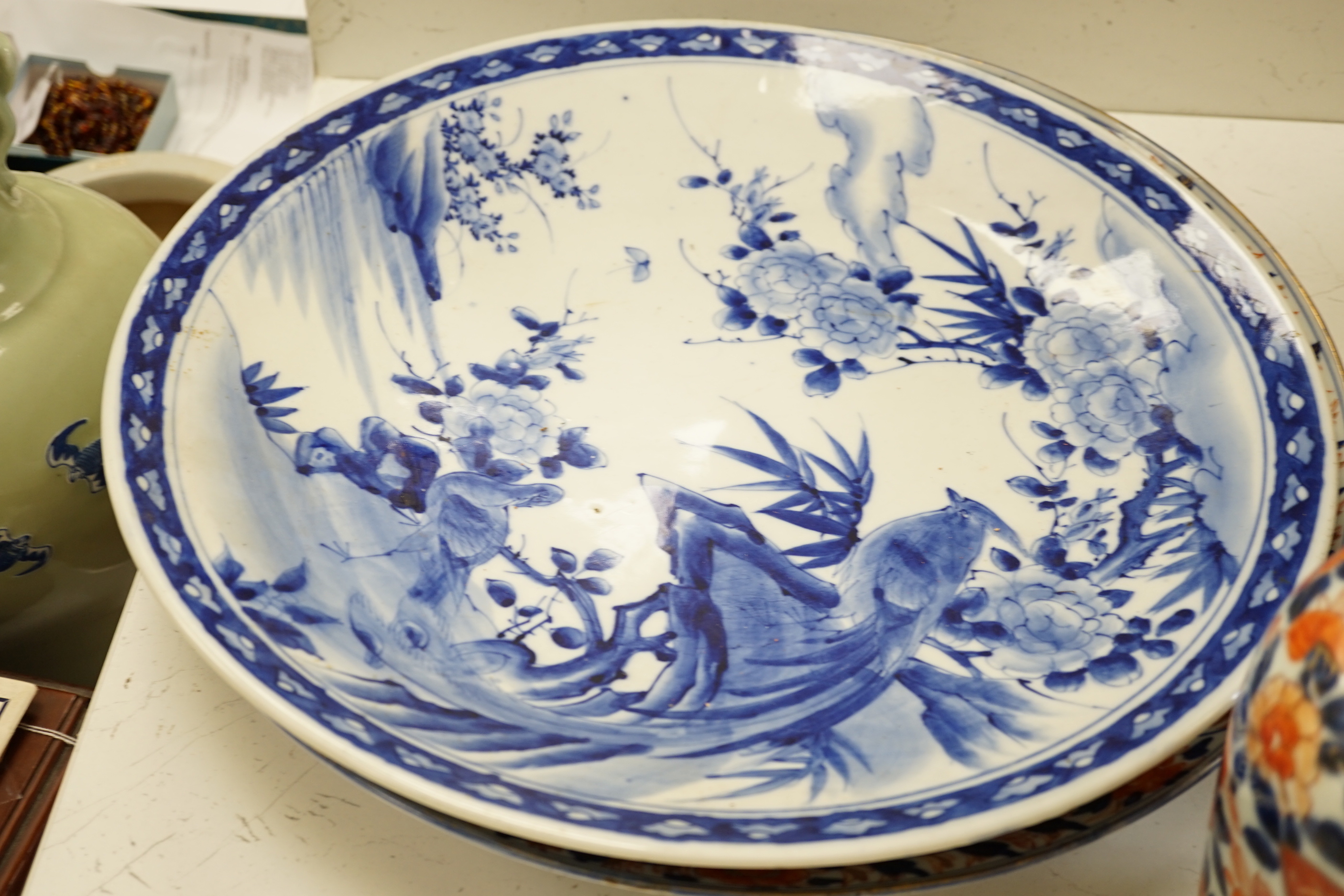 A pair of 19th century Japanese Imari vases, a similar charger, an earlier cracked and riveted charger and a blue and white charger, (5), largest charger 47cm diameter